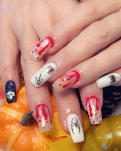 Image of Halloween-themed nails featuring blood dripping, skulls, and spiders.