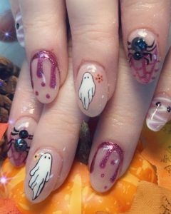 Image of Halloween-themed nails featuring blood dripping, ghosts, and spiders.