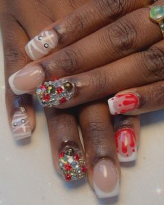 Image of Halloween-themed nails featuring blood dripping, mummies, and rhinestones.