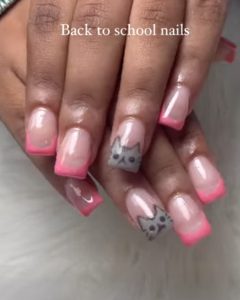 An image of pink-tipped nails with cat illustrations.